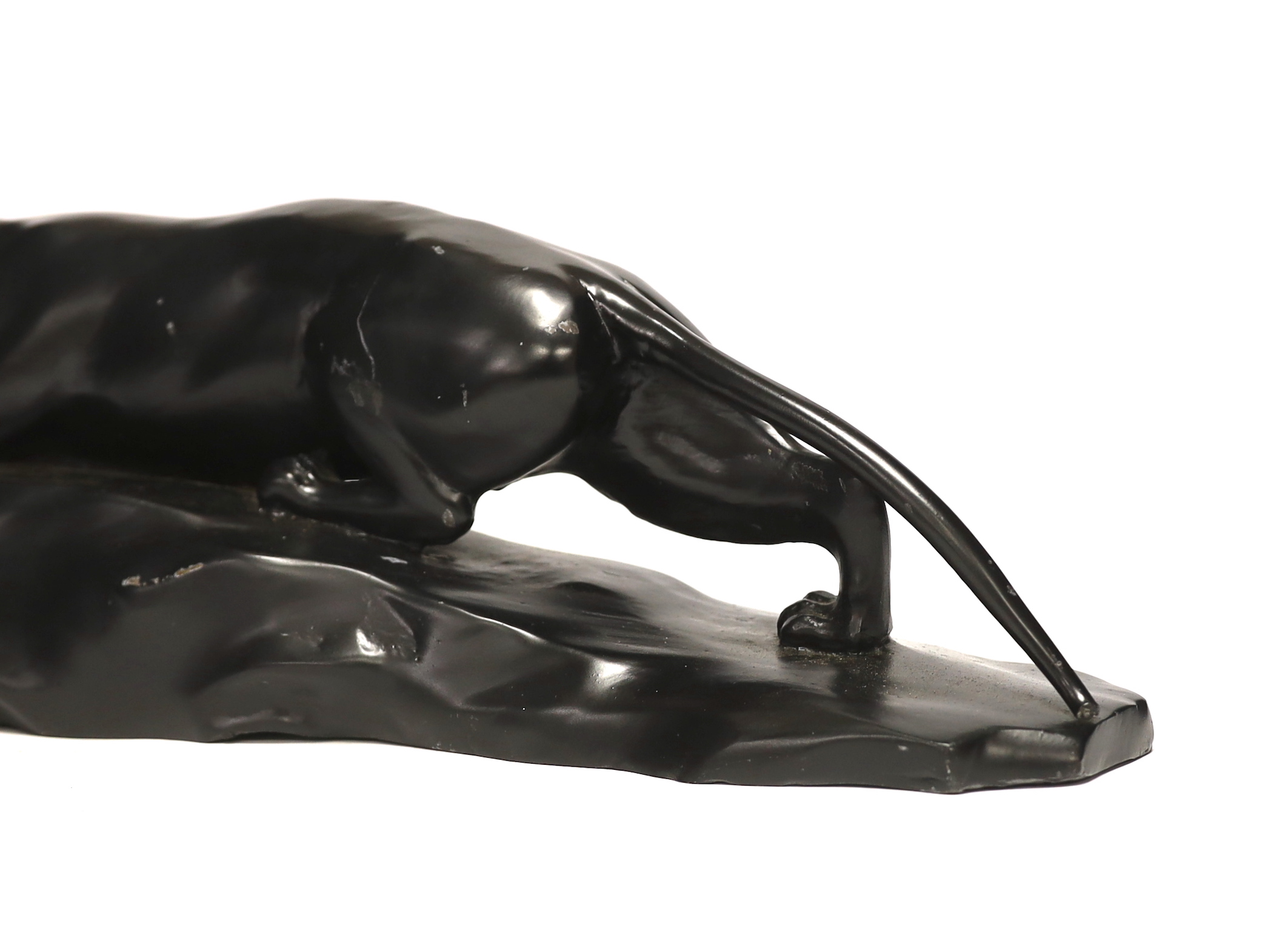 A bronzed black painted spelter panther, 50cm wide